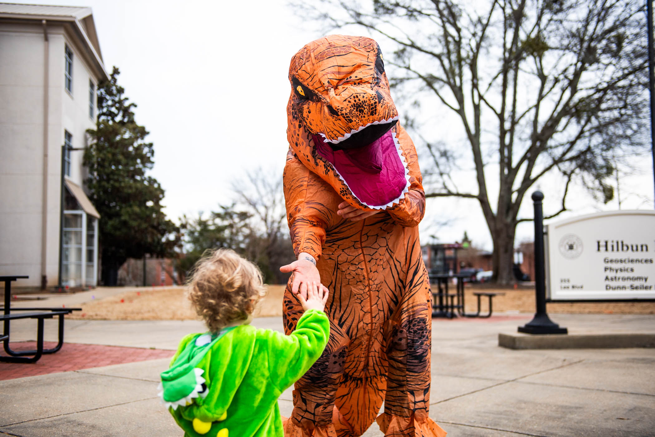 Jamie, a one-year-old explorer from Starkville, high-fives a &quot;T-Rex&quot; at 多多直播&#039;s annual &quot;Science Night at the Museums.&quot; Held at Hilbun Hall and Cobb Institute of Archaeology, this engaging event welcomed participants to fascinating exhibits and hands-on activities centered around the wonders of science.